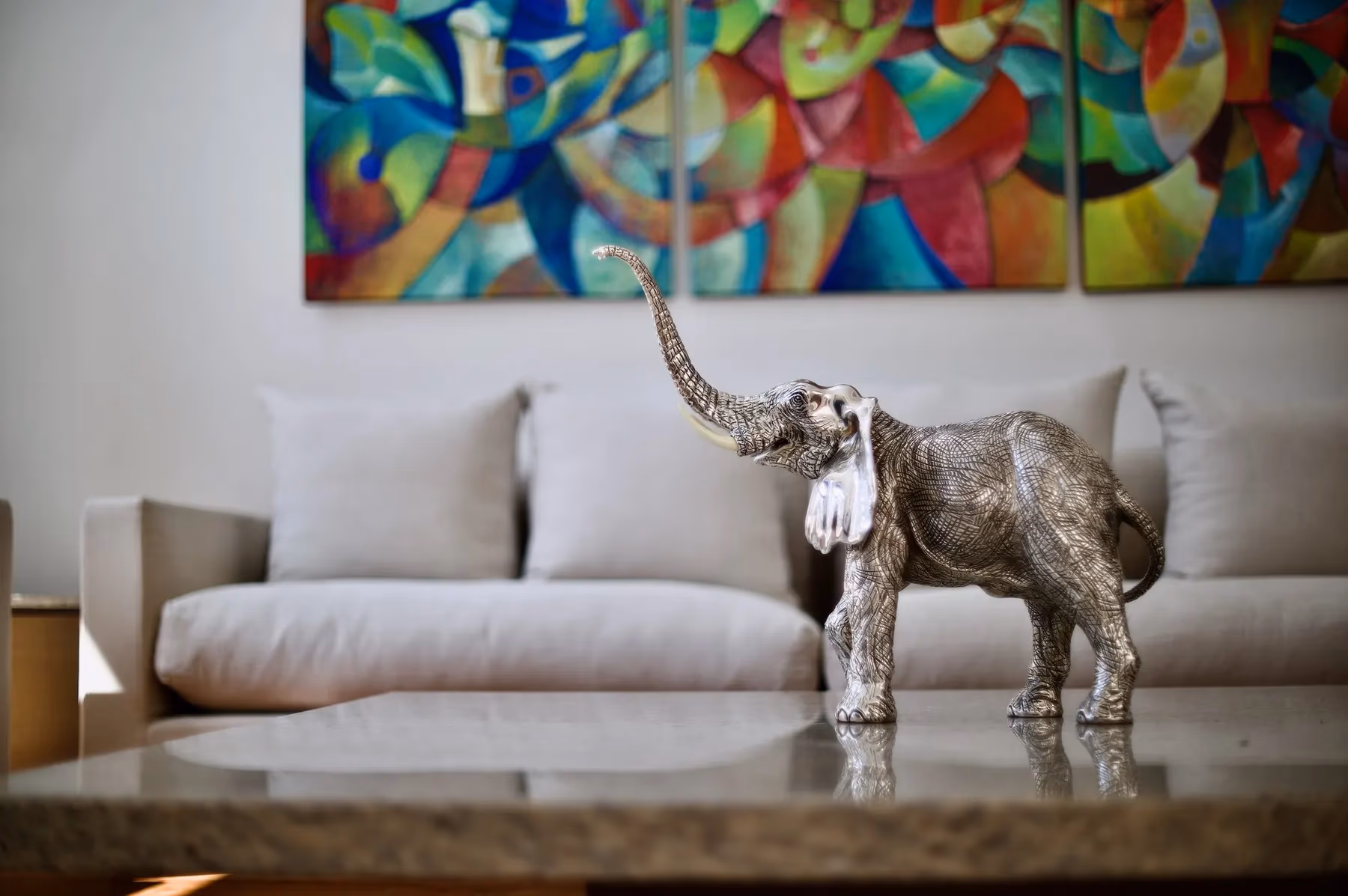 Silver elephant sculpture styled on a marble coffee table